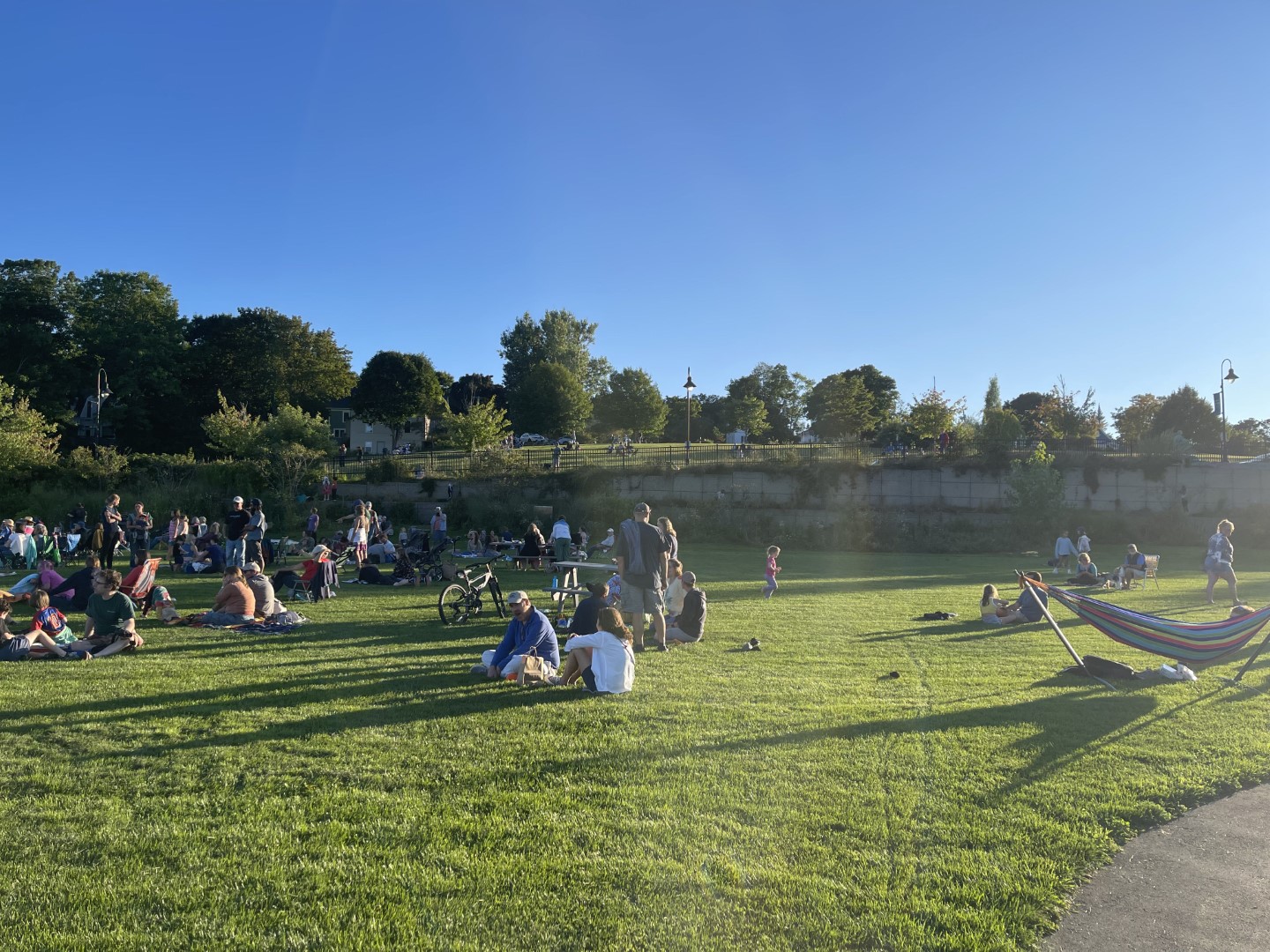 Patrons of the Belfast Summer Night concert series sit and listen to the concert at the Steamboat Landing Park in Belfast, Maine