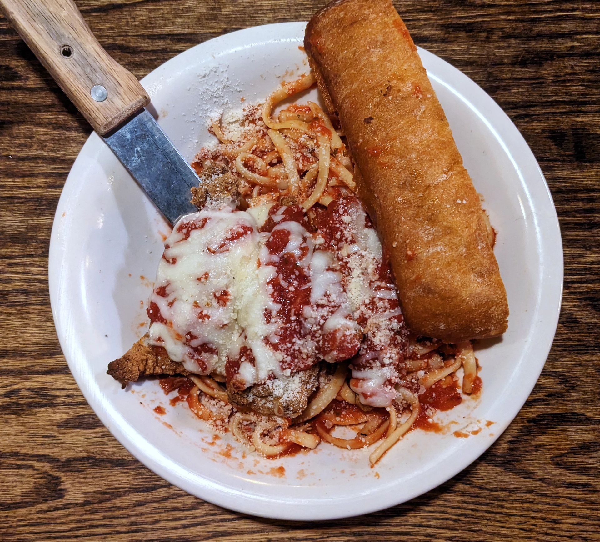 My entree: Chicken Parmesan with Fried Chicken smothered in mozzarella cheese and garlic bread<br>