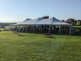 One of the tents with picnic tables and other seating<br>