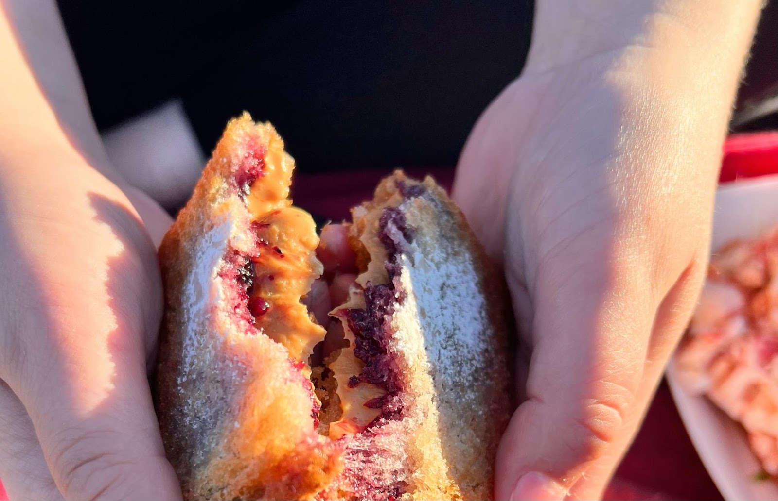 Sarah breaking open a Fried Peanut Butter & Jelly Sandwich